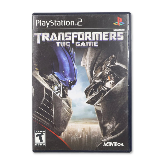 Transformers: The Game for Sony PlayStation 2 - Case front cover - Complete in box or case and game.